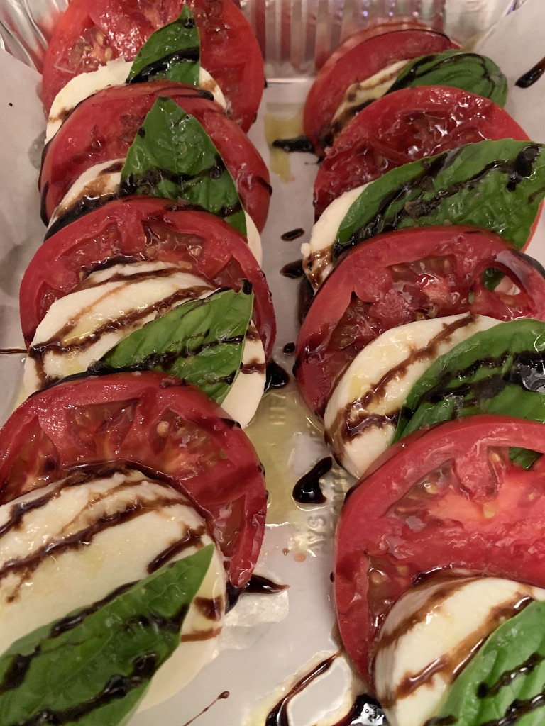 Caprese salad starter, sliced tomato and fresh mozzarella